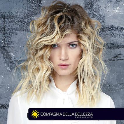 Capelli ricci scalati con ciuffo